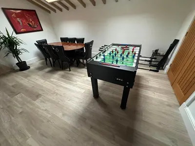 a room with a foosball table and a table and chairs at The Old stables Barn in Old Hurst