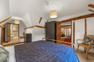 a bedroom with a blue bed in a room at Luces Loft in Castle Hedingham
