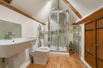 a bathroom with a shower and a toilet and a sink at Luces Loft in Castle Hedingham