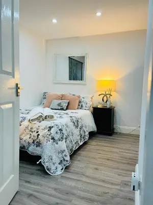 a bedroom with a bed and a mirror on the wall at Hertford Home detached garden parking pet allowed in Hertford