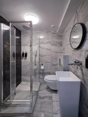 a bathroom with a shower and a toilet and a sink at The Courtyard Lodge in Hitchin