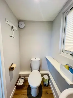 a bathroom with a white toilet and a sink at Romantic Cabin Retreat on 50-Acre Suffolk Farm in Burgh