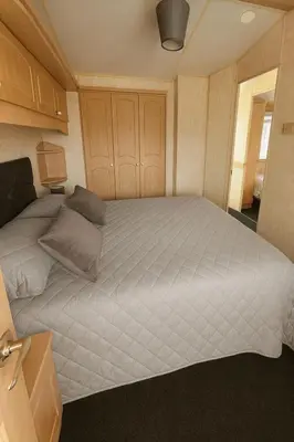 a bedroom with a large bed in a room at Rohannah A&C Ultimate Caravan Retreat in East Mersea