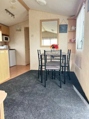 a dining room with a table and chairs at Rohannah A&C Ultimate Caravan Retreat in East Mersea