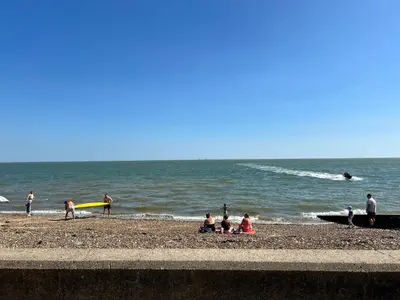 a group of people on a beach with the ocean at Rohannah A&C Ultimate Caravan Retreat in East Mersea