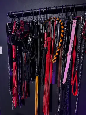 a bunch of umbrellas hanging on a rack at Essex Dungeon Suite in Heybridge