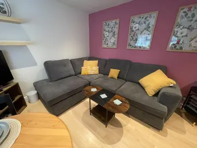 a living room with a gray couch and yellow pillows at Stylish 2 bed apartment - easy walk to Addenbrookes in Cambridge