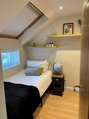 a bedroom with a bed and a window at Stylish 2 bed apartment - easy walk to Addenbrookes in Cambridge