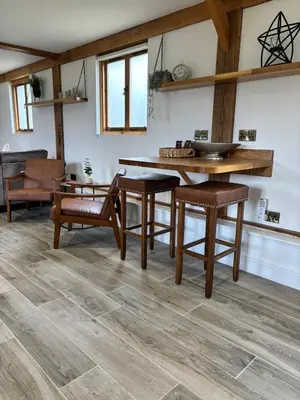 a dining room with a wooden table and chairs at The Lodge in Newbourn