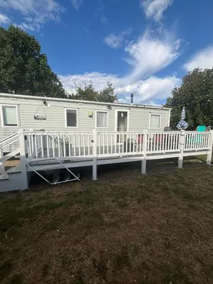 a mobile home with a porch and a deck at Singh&Leite Family RF10 in Jaywick Sands