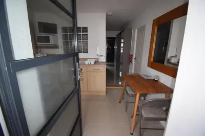 a kitchen with a table and a dining room at Eco Deco in Frinton-on-Sea
