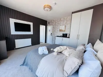 a bedroom with a large bed with two pillows at Pacific Hotel in Clacton-on-Sea