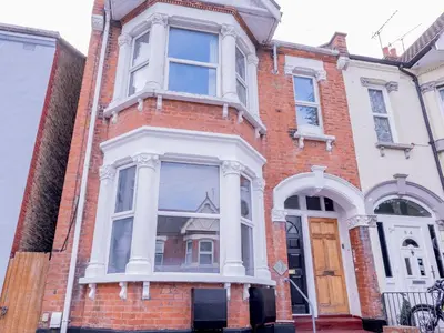 a brick house with a large window on a street at Pass the Keys Comfortable Flat with Patio Sleeps 4 in Westcliff On Sea