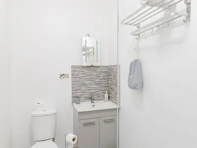 a white bathroom with a sink and a toilet at Pass the Keys Comfortable Flat with Patio Sleeps 4 in Westcliff On Sea