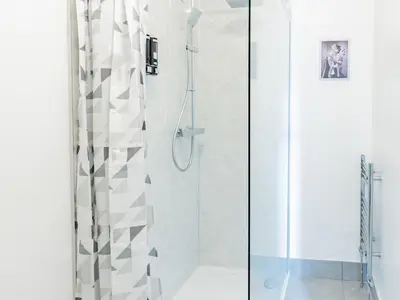 a shower with a glass door in a bathroom at Pass the Keys Comfortable Flat with Patio Sleeps 4 in Westcliff On Sea