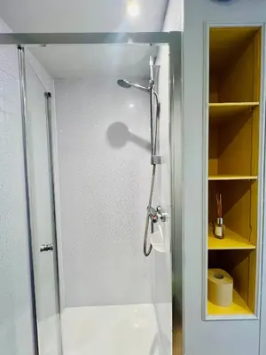 a shower with a glass door in a bathroom at Unique Suffolk Cabin with Countryside Views in Burgh