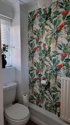 a bathroom with a toilet and a floral wallpaper at Your home away from home in Bury Saint Edmunds