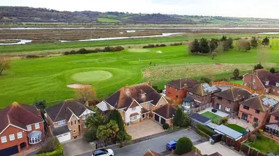 an aerial view of a house with a golf green at Relaxing Coastal Getaway Perfect for Families in Canvey Island