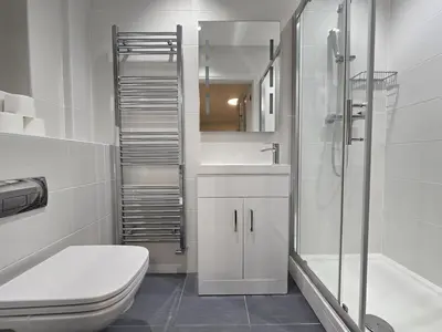 a bathroom with a toilet and a sink and a shower at Relaxing Coastal Getaway Perfect for Families in Canvey Island