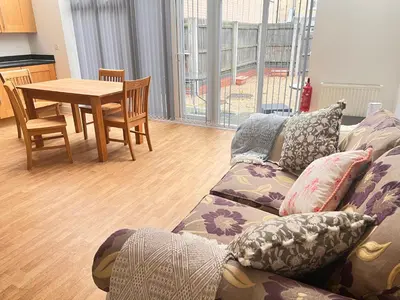 a living room with a couch and a table at 4 Bedroom House Colchester in Colchester