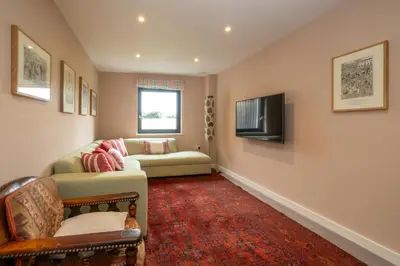 a living room with a couch and a tv at Sedge House, Eastbridge, Close to the coast, RSPB Nature Reserve, Dunwich, Sizewell and Leiston - Managed by Aldeburgh Coastal Cottages in Theberton