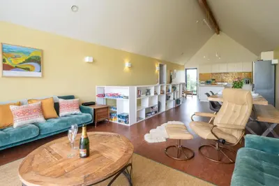 a living room with a couch and a table at Sedge House, Eastbridge, Close to the coast, RSPB Nature Reserve, Dunwich, Sizewell and Leiston - Managed by Aldeburgh Coastal Cottages in Theberton