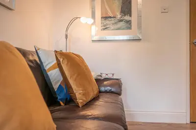 a couch with two pillows on it in a living room at 19BC, Aldeburgh in Aldeburgh