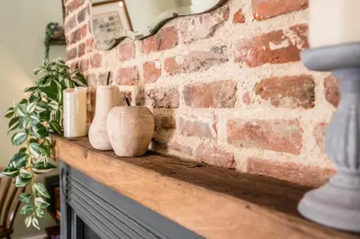 a brick wall with vases sitting on top of a counter at Market View, Framlingham in Framlingham