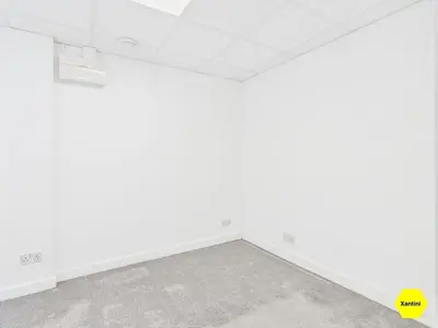 an empty room with white walls and a yellow box at New Spacious apartment in Milton