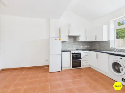 a kitchen with a white refrigerator and a dishwasher at New Spacious apartment in Milton