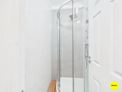a shower with a glass door in a bathroom at New Spacious apartment in Milton