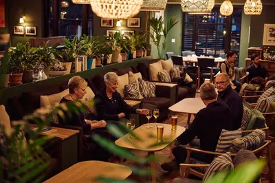a group of people sitting at tables in a restaurant at The White Hart Inn in West Mersea