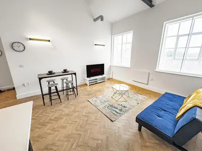 a living room with a couch and a table at Bright & Cozy in Chelmsford in Chelmsford