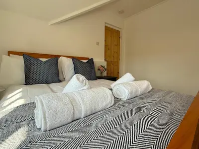 a bedroom with a bed with two pillows on it at 2 bed Elegant Flat in Stansted with parking in Stansted Mountfitchet