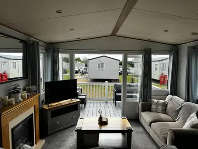 a living room with a couch and a tv at Cosy 2 bed in Dovercourt Holiday Park -Sleeps 6 in Harwich