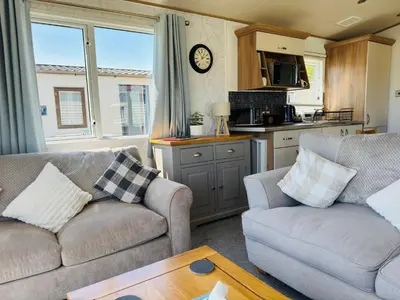 a living room with two couches and a kitchen at Cosy 2 bed in Dovercourt Holiday Park -Sleeps 6 in Harwich