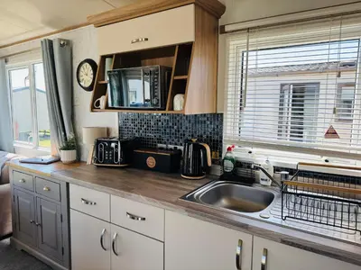 a kitchen with a sink and a counter top at Cosy 2 bed in Dovercourt Holiday Park -Sleeps 6 in Harwich