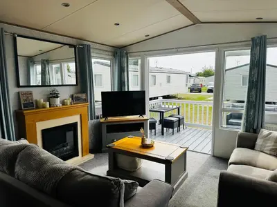 a living room with a fireplace and a television at Cosy 2 bed in Dovercourt Holiday Park -Sleeps 6 in Harwich