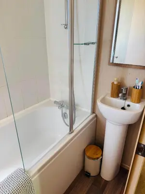 a bathroom with a shower tub and a sink at Cosy 2 bed in Dovercourt Holiday Park -Sleeps 6 in Harwich
