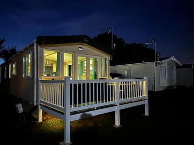 a small house with a white railing on a porch at Cosy 2 bed in Dovercourt Holiday Park -Sleeps 6 in Harwich