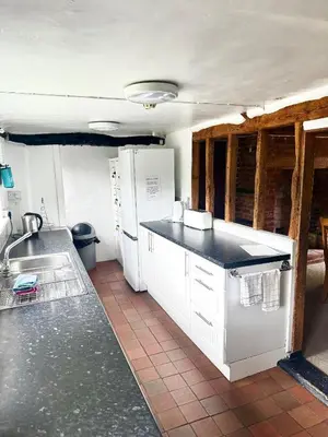 a kitchen with white appliances and a tile floor at Memorial University, Harlow Campus in Burnt Mill