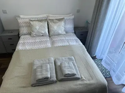 a bedroom with a bed with two towels on it at Little side house in Cambridge in Trumpington