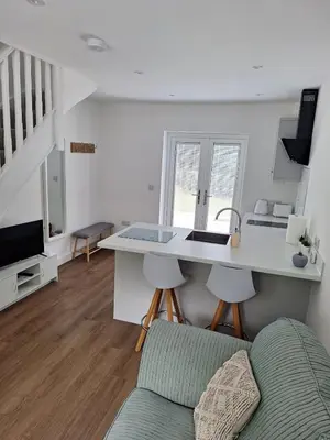 a kitchen and living room with a counter and a couch at New Annexe in Gosfied in Gosfield