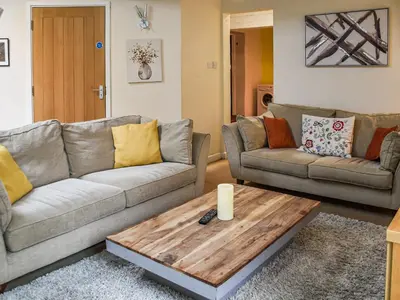 a living room with two couches and a coffee table at The Pool House - Uk48229 in Tibenham