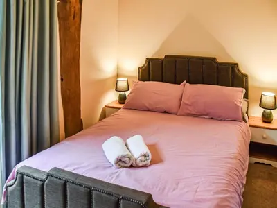 a bedroom with a bed with two towels on it at The Pool House - Uk48229 in Tibenham
