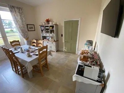 a kitchen and dining room with a table and chairs at The Old Vicarage BandB