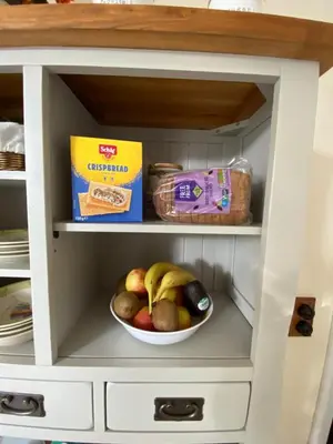 a cupboard with a bowl of fruit in it at The Old Vicarage BandB