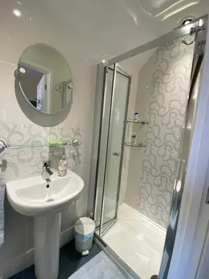 a bathroom with a sink and a shower at The Old Vicarage BandB