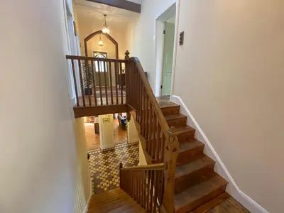 a staircase in a house with wooden stairs and a hallway at The Old Vicarage BandB