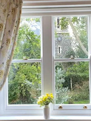 a window with a vase of flowers on a window sill at The Old Vicarage BandB